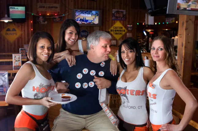 Restaurant chain known for uniformed waitresses is ‘going bankrupt’ Jessica Kwong Jessica Kwong Published February 21, 2025 4:52pm Updated February 21, 2025 4:52pm Comments AX769P Hooters girls with a male customer on his birthday Hooters is reportedly preparing to file for bankruptcy (Picture: Alamy Stock Photo) The American restaurant chain Hooters, famous for its waitresses wearing tight-fitting sporty uniforms, is reportedly heading toward bankruptcy. Hooters is preparing to file for bankruptcy to restructure its business likely in the next two months, sources told Bloomberg on Friday. The plans, underway with the law firm Ropes & Gray, are not definite. The casual dining chain has experienced a drop in customers and closed some locations in recent years. In 2021, Hooters sold roughly $300million in bonds backed with assets which included franchise fees. Hooters went ‘from humble beginnings to worldwide success’, according to the history page on its website. symbol 00:00 02:24 Read More J8J8CC Montreal, Canada - May 27, 2017: Hooters girls at the window of the restaurant on the trendy Crescent Street that opened in March of 2017. Hooters is a sports bar-style casual dining chain with waitresses who dress in a signature uniform (Picture: Alamy Stock Photo) The first Hooters opened in 1983 in Clearwater, Florida, when ‘six businessmen with no restaurant experience whatsoever got together to open a place they couldn’t get kicked out of’, states the site. ‘More than three decades later, the Hooters brand has grown into an international sensation, with more than 420 Hooters in 29 countries,’ it states. ‘How do you say Hooters in all those languages? Here’s a hint. It’s just Hooters.’ The chain’s restaurants serve sports bar-type fare, beer and are equipped with TV screens broadcasting popular games. OLYMPUS DIGITAL CAMERA Hooters Girls are the restaurant chain’s iconic waitresses (Picture: Shutterstock) Its waitresses, called Hooters Girls, wear short orange shorts and low-cut tank tops or T-shirts with the company’s name in orange and an owl’s eyes behind the two O’s in Hooters. The signature look has prompted the company to include a section in its frequently asked questions on whether the public can buy the Hooters Girl uniform. ‘The Hooters Girl is every bit as special and coveted to us as she is to you. As a result, the Hooters Girl uniform is only available to actively employed Hooters Girls. We are very protective of our girls and our brand,’ it reads. More Trending Elon Musk holds a chainsaw reading "Long live freedom, damn it" during the annual Conservative Political Action Conference (CPAC) at the Gaylord National Resort & Convention Center at National Harbor in Oxon Hill, Maryland, on February 20, 2025. (Photo by SAUL LOEB / AFP) (Photo by SAUL LOEB/AFP via Getty Images) Elon Musk wields a chainsaw and dances on stage in bizarre appearance US 22 hours ago By Sarah Hooper Donald Trump says Zelensky brings 'no cards' and isn't important in Russia peace talks Luigi Mangione wears bulletproof vest in first court appearance since arraignment Amazon delivery driver runs over woman and flees after getting out to look at her ‘We do, however, offer the classic Hooters Girl orange shorts. We also sell a ribbed tank top and the lycra tank top just like our girls wear. Name tags, pouches, and panty hose are not available to the public.’ Hooters restaurant logo in thailand The first Hooters opened in 1983 in Clearwater, Florida (Picture: Shutterstock) Hooters has been working on its debt issues with its attorneys and a boutique firm, Accordion Partners. Debtholders have also reportedly asked Houlihan Lokey Inc to advise. Its reported bankruptcy preparations come as numerous restaurant chains have closed more locations in the struggle to survive. Last week, the casual diner chain Denny’s confirmed it is closing 38 more locations on top of the 150 it had already announced would be axed. Retail stores in the US are also in trouble, and a research group predicts that 15,000 stores will close across the country this year – double the figure last year.