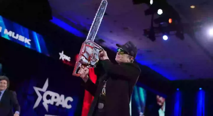 Elon Musk waves ‘chainsaw for bureaucracy’ on stage in bizarre CPAC appearance