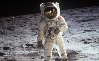 Artist enhanced reflection of Buzz Aldrin's helmet in famous moon photo and pointed towards one detail
