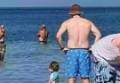 Family left horrified after spotting scary detail in background of beach photo