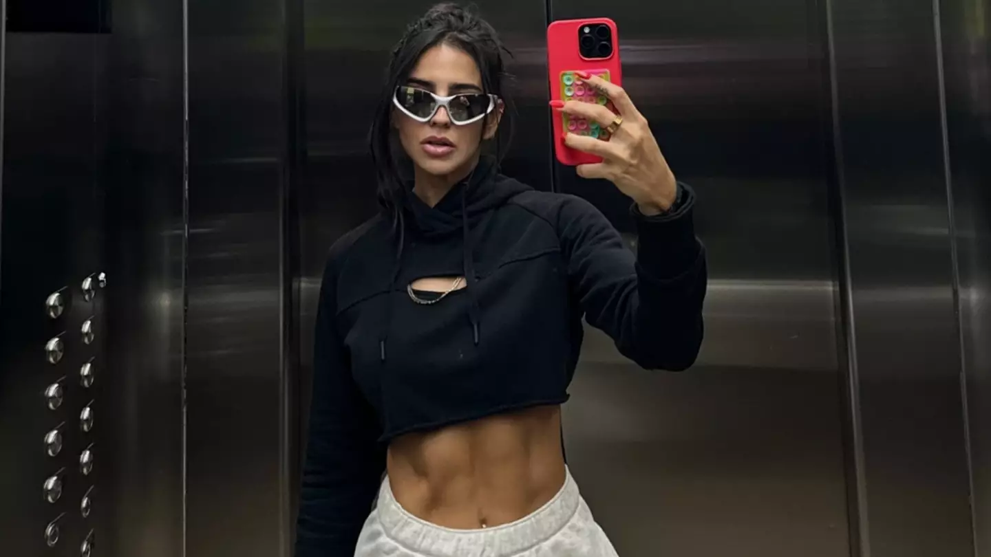 Influencer who filmed herself doing intense workout in the middle of plane aisle sparks online debate